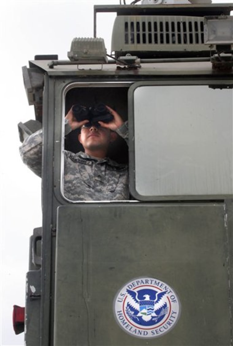 A Texas National Guardsman, Cpl. Martinez, surveys the terrain from a Border Patrol Skybox near the Hidalgo International Bridge in Hidalgo, Texas.